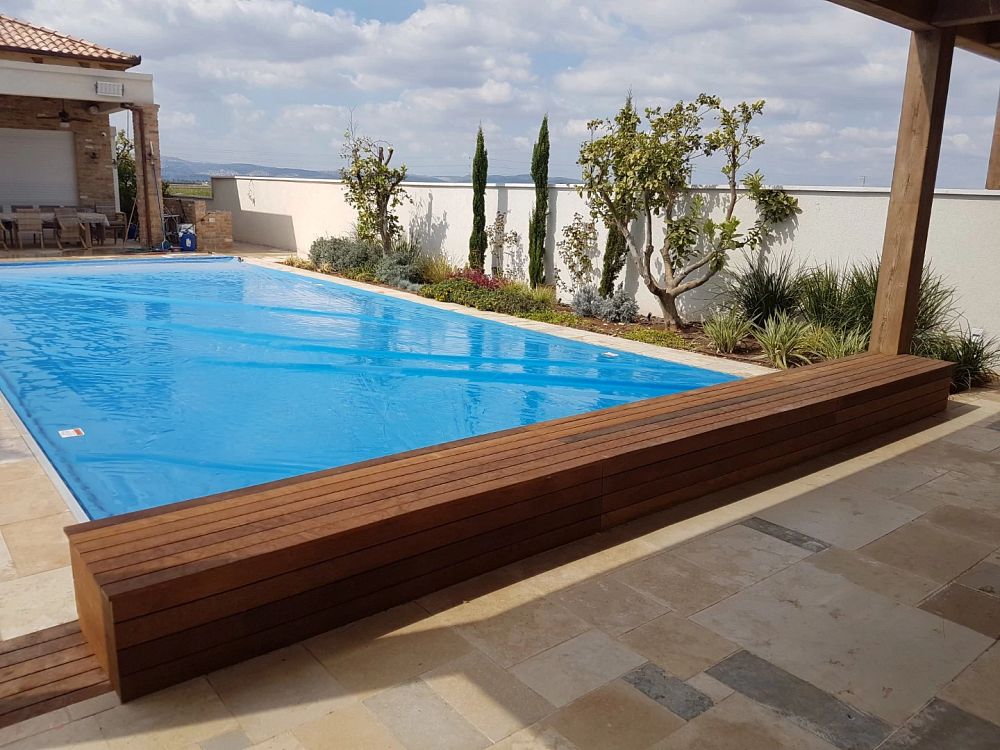 overflow pool with horizontal flush track and wood bench.